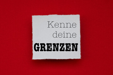 Wall Mural - Text -Kenne deine Grenzen- auf angerissenem Papier auf rotem Tonzeichenkarton