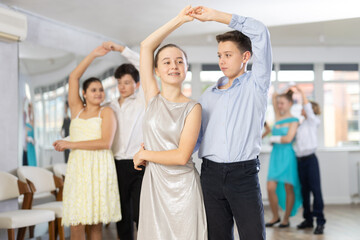 Wall Mural - Couple boy and girl rehearsing waltz dance in studio