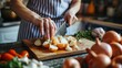 © Barbara Taylor - woman slicing onions with knife on a kitchen cutting board