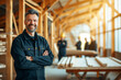 Confident Carpenter in Woodworking Workshop, Skilled Craftsmanship, Team in Background