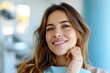 © LifeMedia - A stylish woman radiates confidence and joy as she poses for a portrait, her brown layered hair framing her flawless skin and captivating smile while her hand rests gently on her chin, adorned with a