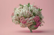 Artificial human brain with flowers and herbs on pink background. 