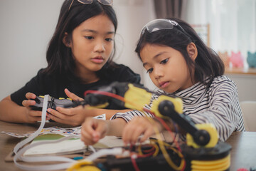 Asian students enjoy Machine Learning Robot arms Control robots in technology class, stem education robot arms for digital automation software for artificial intelligence AI. STEM education concept.