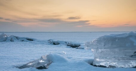 Wall Mural - Sunset over a frozen lake in winter