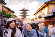 © maya1313 - Travel, muslim travel,  woman girl tourist Two Asian friends but different religions walking at Yasaka Pagoda and Sannen Zaka Street in Kyoto Japan, Yasaka Pagoda is the famous landmark and travel.