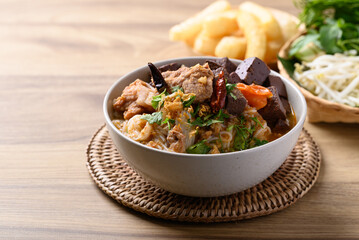 Canvas Print - Northern Thai food (Kanom Jeen Nam Ngeaw), Spicy rice noodles soup with pork and pork blood eating with fresh vegetables