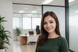 © PNG&Background Image - Happy businesswoman standing in a modern green office space with copy space.
