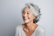 middle-aged woman in her 40s, with white gray hair, smiling beautifully as a skin care product model
