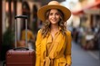 A young beautiful successful girl traveler in a bright orange suit with a plastic suitcase. Theme of tourism and active pastime.