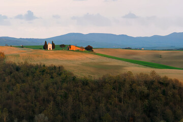 Dusk scenery of a lovely church (The Chapel of Our Lady of Vitaleta ) standing on a grassy hillside with forests in foreground in Pienza, Italy ~ Beautiful sunset scene of rolling hills in Tuscany