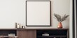 © DIMENSIONS - In a stylish living room, a black mockup featuring a square frame hangs elegantly above a low cabinet against a pristine white wall, adding a touch of sophistication to the space.
