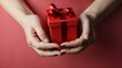 © ArtistiKa - a stunning woman with delicate hands holds a vibrant red present, valentines day concept, woman hands holding a red present, horizontal photo