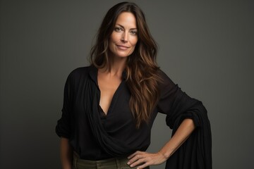 Wall Mural - Portrait of a beautiful woman with long brown hair in a black shirt