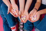 Fototapeta  - Hands holding candy hearts with blue jeans and valentine's day socks