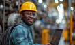 © STORYTELLER AI - Manufacturing Factory black male Mechanical Engineer Works on Personal Computer at Metal lathe industrial manufacturing factory. Engineer Operating lathe Machinery. African people.