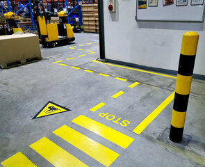 Walkway,footpath,Industrial building corridor painted yellow between parallel yellow lines on abstract cement background. Sidewalk Negotiation Safety Concept