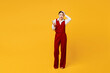 Full body shocked scared young lawyer employee business woman of Asian ethnicity wear formal red vest shirt work at office hold head use mobile cell phone isolated on plain yellow background studio.