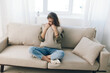 © SHOTPRIME STUDIO - Distressed Woman Resting on Couch, Feeling Sad and Worried, Expressing Mental Health Pain at Home