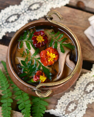 Wall Mural - Marigold flowers in water in a copper saucepan, herbal tea, decoction of medicinal plants, close-up