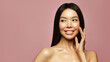 © Beauty Agent Studio - Beauty portrait of Asian young brunette woman with a glowing smooth skin  and long healthy hair on the pink background. Skincare treatment and spa concept.
