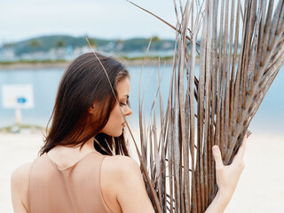 Poster - Ocean Beauty: A Young Lady's Serene Sunset Portrait Evoking Summer Vibes, Fashion and Relaxation on a Tropical Beach