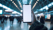 © BeautyStock - Hand holding an isolated smartphone device with blank empty white screen at the airport station, travel business communication technology concept