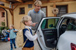 © Halfpoint - Children getting into the car, father taking them to school and kindergarten before going to work.