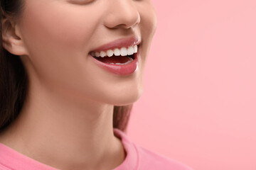 Wall Mural - Woman with clean teeth smiling on pink background, closeup. Space for text