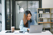© laddawan - Woman freelancer is working her job on computer tablet and laptop Doing accounting analysis report real estate investment data, Financial