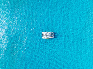 Wall Mural - Drone view of a sailing yacht. Luxury transportation. Vacation and holidays. Summer time for sea travel. The sea bay. Photo for background and wallpaper.