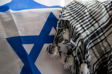 Wall Mural - Israel flag and Palestinian scarf together lying on a rope to dry after washing or lying on a surface