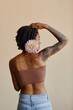 © VISTA by Westend61 - Young woman with short hair holding peony flower against brown background