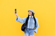 © VISTA by Westend61 - Cheerful woman taking selfie in front of yellow wall