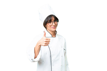 Wall Mural - Young caucasian chef  woman over isolated chroma key background with thumbs up because something good has happened