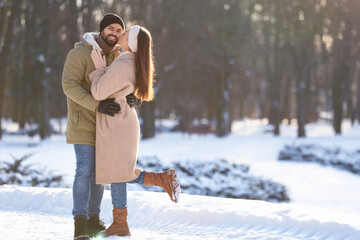 Poster - Beautiful young couple enjoying winter day outdoors