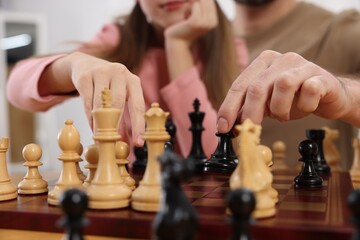 Poster - Father teaching his daughter to play chess, closeup