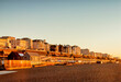  Brighton, East Sussex, UK - Hotels on the seafront at Brighton, from the beach during winter sunrise. Clear blue sky.
