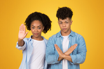 Wall Mural - Displeased young African American woman standing with arms crossed