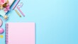 © Muamanah - Stationary for kindergarten school children, in a flat lay style seen from above on the study table. With a bright pink color. Binder roll book and pen.