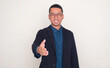 © KrishnaTedjo - Asian businessman smiling at the camera and offering handshake