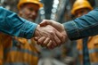 © Hitesh - Two men builder and architect shake hands at construction site