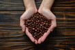 hands holding roasted brown specialty coffee close-up