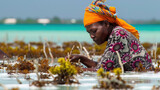 Fototapeta  - Women harvest the seaweed for soap, cosmetics and medicin on a sea plantation in traditional dress, island Zanzibar, Tanzania, East Africa