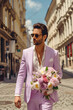 © Olga - man in a suit with a bouquet of flowers on the street