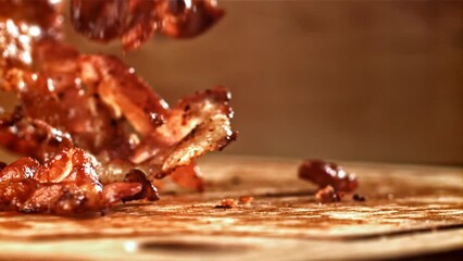 Sticker - Roasted slices of bacon fall on a wooden table. Filmed on a high-speed camera at 1000 fps. High quality FullHD footage