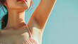 Closeup young beautiful woman showing armpit with smooth clean skin on solid background