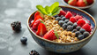 A health-focused breakfast bowl filled with acai fresh fruits granola and honey drizzle.