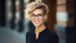 Vertical protrait of an attractive young girl with short hair, wearing glasses and street style clothes, leaning on a brick wall.