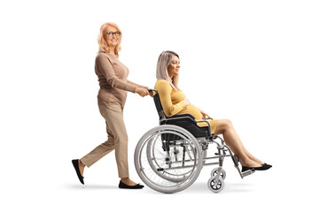 Poster - Middle aged woman pushing a pregnant woman in a wheelchair