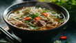 A steaming bowl of Pho with tender beef rice noodles and aromatic herbs in a rich broth.